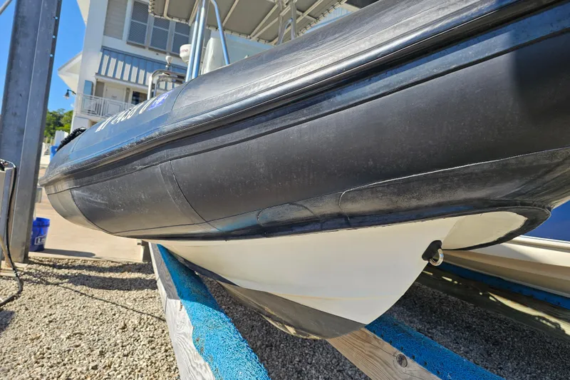 Slide: The Image of 2007 Ribcraft 6.5 boat on a trailer, close-up view of hull and inflatable tubes. - 3