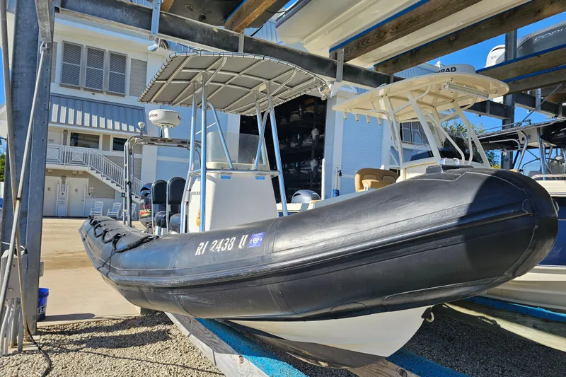 Slide: The Image of 2007 Ribcraft 6.5 inflatable boat on a rack, with a canopy and modern equipment. - 4