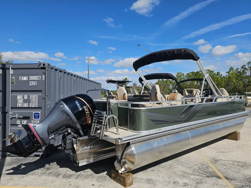 Slide: The Image of 2026 Avalon Venture 85 Tritoon with Yamaha engine, parked outdoors. - 23
