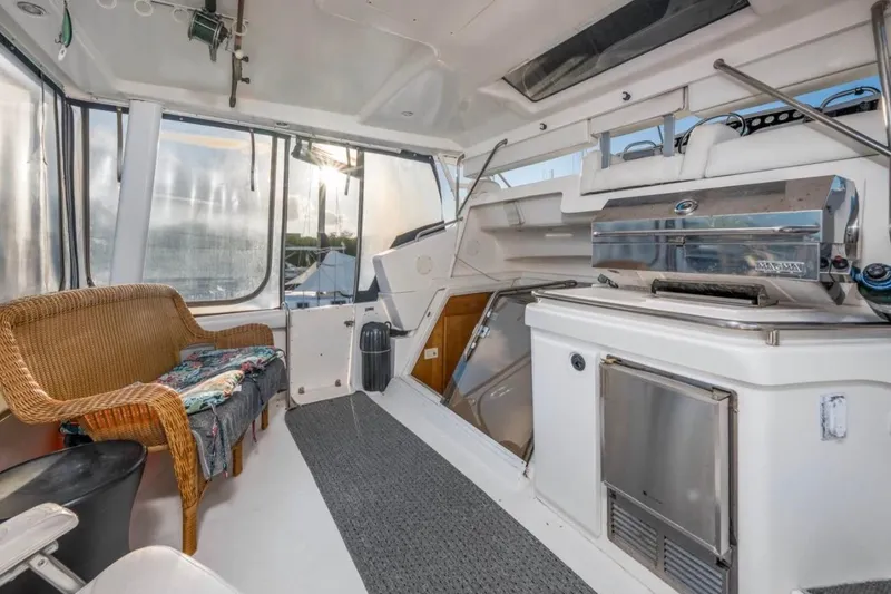 Slide: The Image of 1998 Silverton 40 Convertible yacht deck with ocean view and ladder. - 11