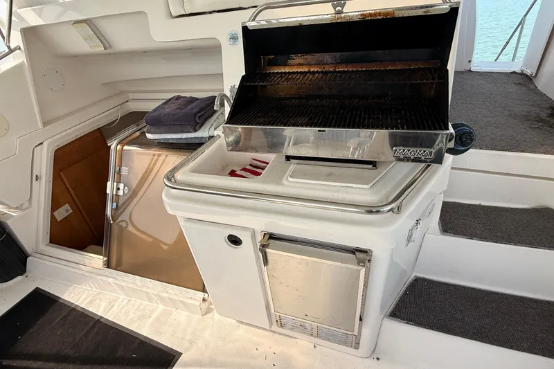 Slide: The Image of 1998 Silverton 40 Convertible yacht with built-in grill and storage area. - 16