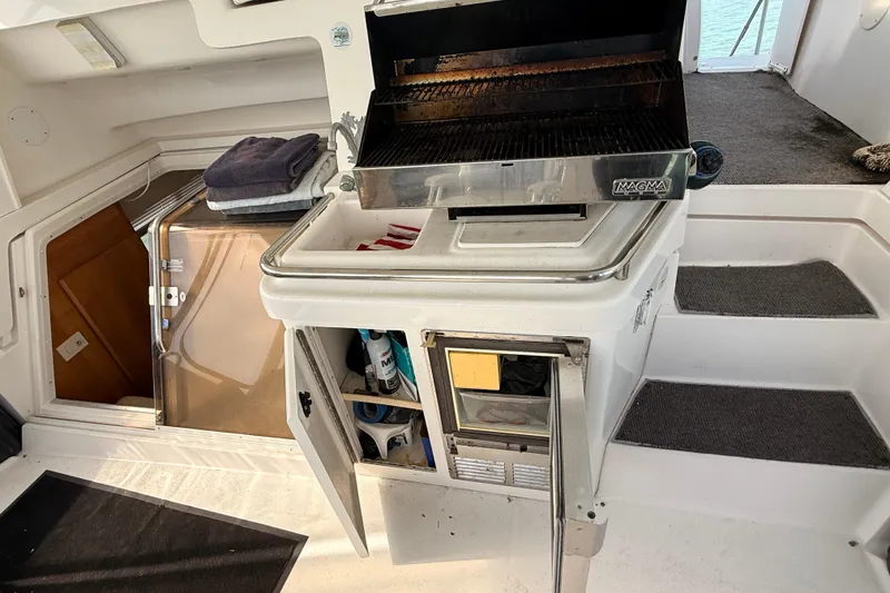 Slide: The Image of Outdoor grill setup on 1998 Silverton 40 Convertible yacht with storage and towels. - 17