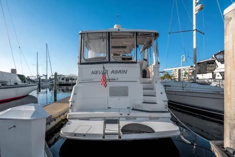 Slide: The Image of 1998 Silverton 40 Convertible yacht on calm water under a clear sky. - 2