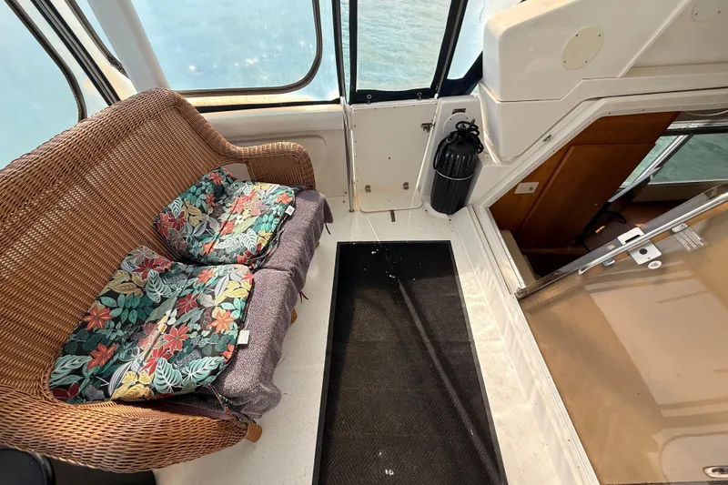 Slide: The Image of 1998 Silverton 40 Convertible interior with wicker seating and floral cushions. - 20