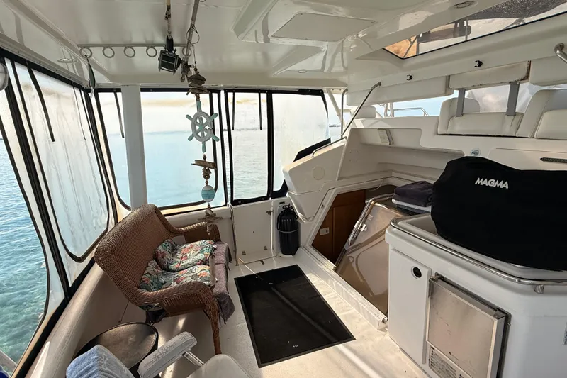 Slide: The Image of Interior of a 1998 Silverton 40 Convertible yacht with wicker seating and ocean view. - 21