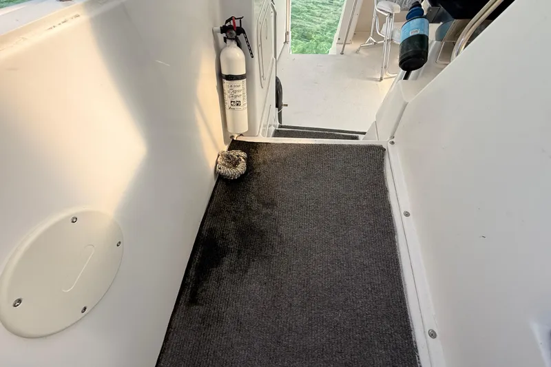 Slide: The Image of 1998 Silverton 40 Convertible boat interior with fire extinguisher and carpeted steps. - 24