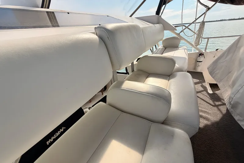Slide: The Image of Interior seating of 1998 Silverton 40 Convertible yacht with white leather upholstery. - 25
