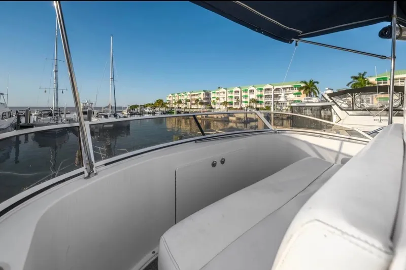 Slide: The Image of 1998 Silverton 372 Motor Yacht docked in a sunny marina with waterfront buildings. - 29