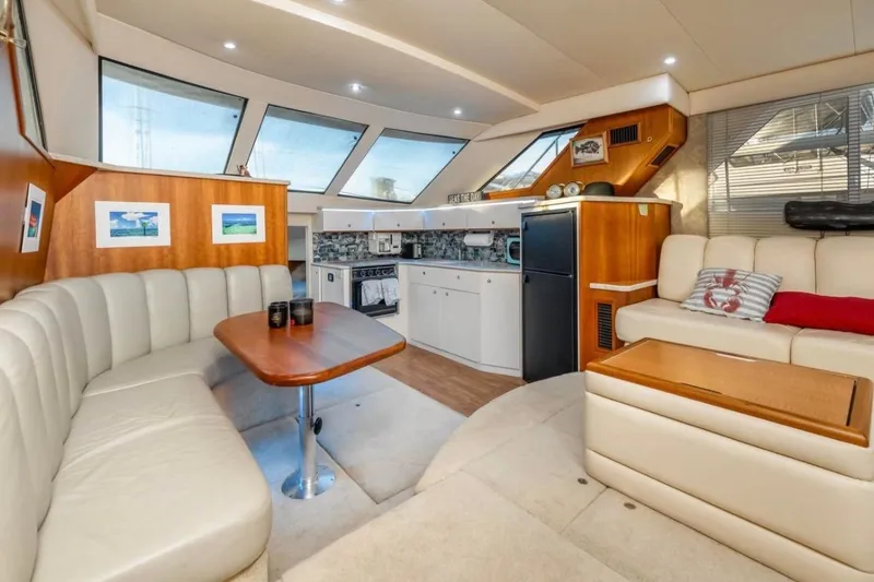 Slide: The Image of 1998 Silverton 40 Convertible yacht on calm sea, rear view with blue flag. - 3