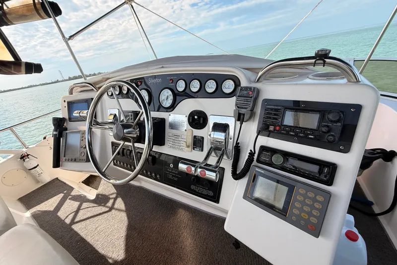 Slide: The Image of 1998 Silverton 40 Convertible yacht helm with steering wheel and navigation instruments. - 30