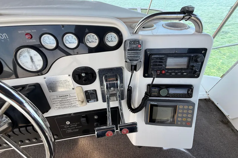 Slide: The Image of Control panel of a 1998 Silverton 40 Convertible yacht with gauges and communication devices. - 31