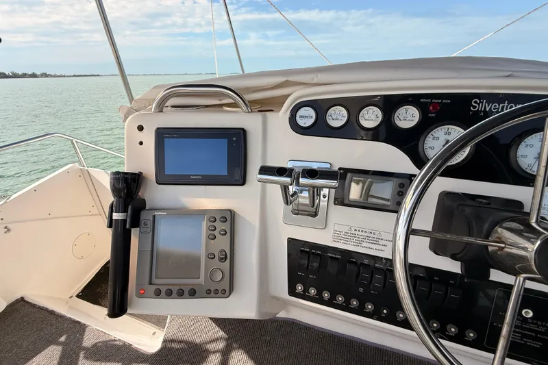 Slide: The Image of 1998 Silverton 40 Convertible yacht helm with navigation instruments and steering wheel. - 35