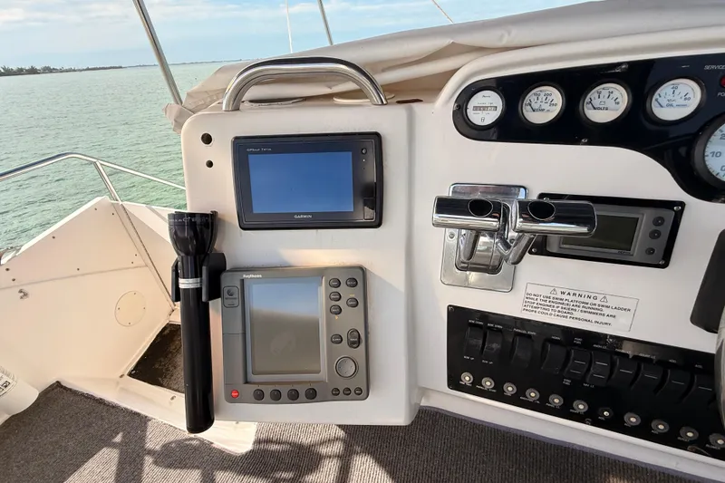 Slide: The Image of Control panel of a 1998 Silverton 40 Convertible boat with navigation equipment. - 36