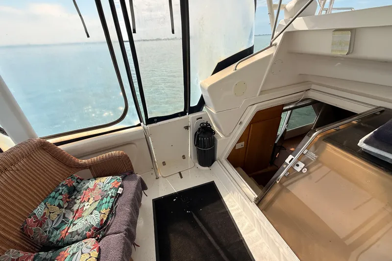 Slide: The Image of 1998 Silverton 40 Convertible yacht interior with wicker seating and ocean view. - 38