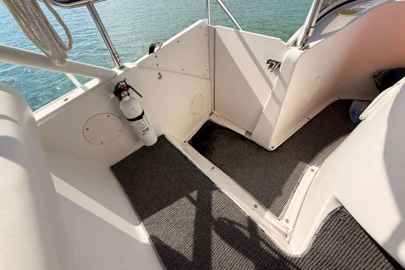 Slide: The Image of 1998 Silverton 40 Convertible boat interior with fire extinguisher and carpeted flooring. - 39