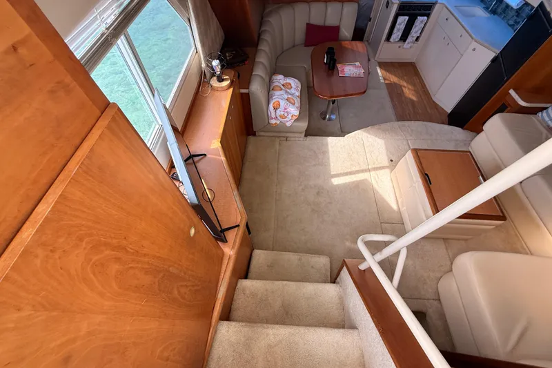 Slide: The Image of Interior of 1998 Silverton 40 Convertible yacht with cozy seating and modern amenities. - 41