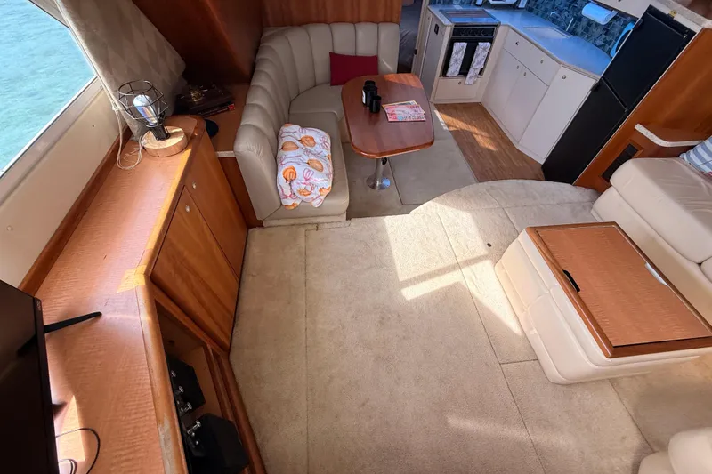 Slide: The Image of Interior of 1998 Silverton 40 Convertible yacht with cozy seating and modern kitchen. - 42