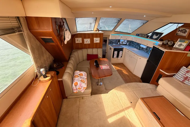 Slide: The Image of Luxurious interior of a 1998 Silverton 40 Convertible yacht with cozy seating and modern kitchen. - 43