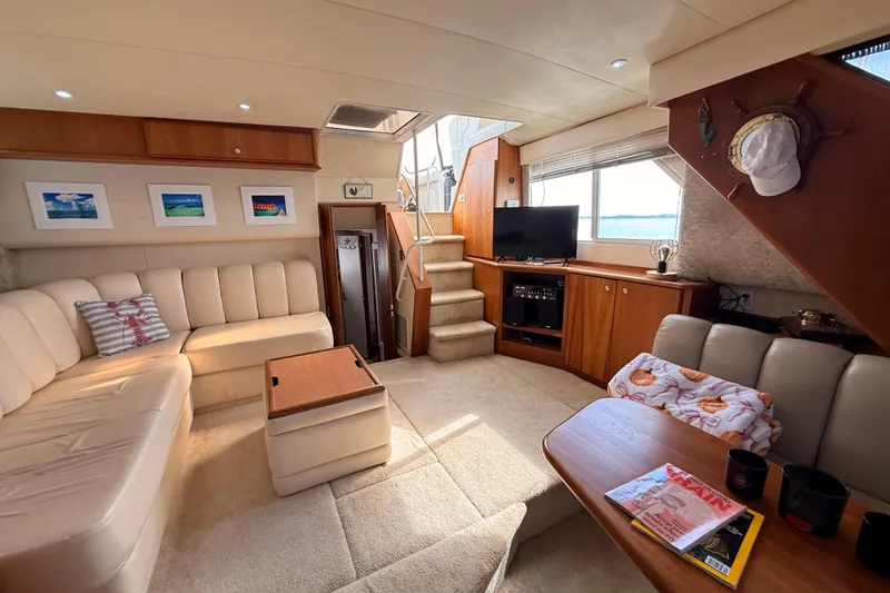 Slide: The Image of Luxurious interior of a 1998 Silverton 40 Convertible yacht with cozy seating and decor. - 45