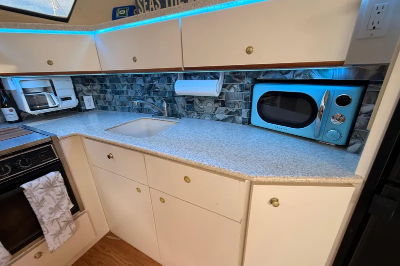 Slide: The Image of 1998 Silverton 40 Convertible kitchen with modern appliances and blue LED lighting. - 51
