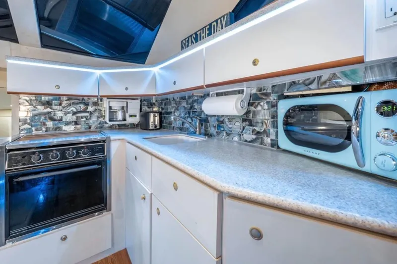 Slide: The Image of Modern kitchen in 1998 Silverton 372 Motor Yacht with sleek appliances and stylish backsplash. - 52