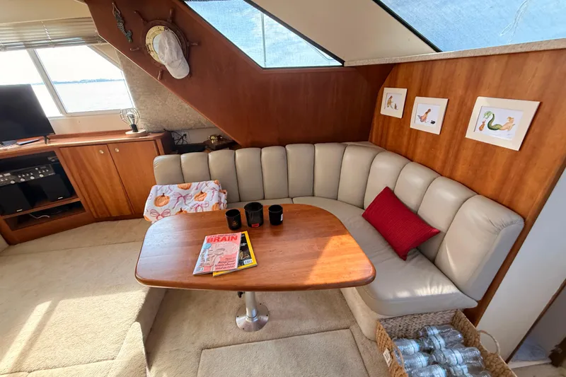 Slide: The Image of 1998 Silverton 40 Convertible yacht interior with cozy seating, table, and decor. - 53