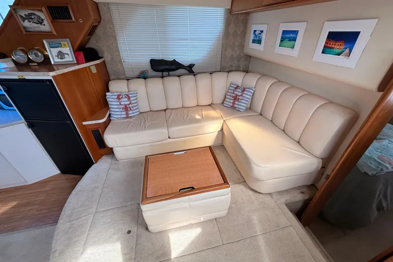 Slide: The Image of Interior of 1998 Silverton 40 Convertible yacht with cream leather seating and nautical decor. - 54