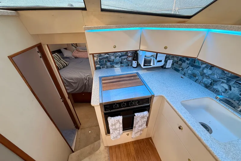 Slide: The Image of 1998 Silverton 40 Convertible yacht interior with kitchen and bedroom view. - 56