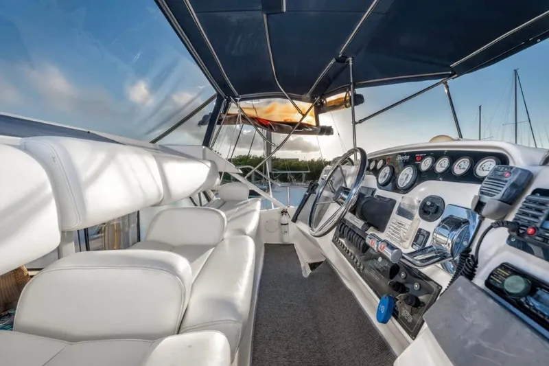 Slide: The Image of 1998 Silverton 372 Motor Yacht on calm water under a partly cloudy sky. - 6