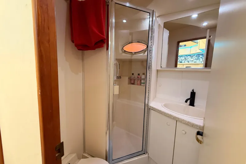 Slide: The Image of Bathroom interior of 1998 Silverton 40 Convertible yacht with shower and sink. - 63