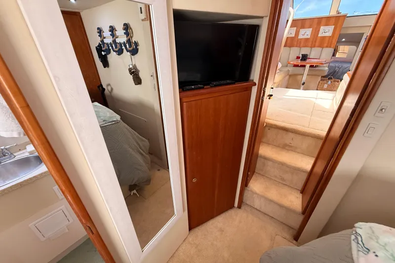 Slide: The Image of Interior of 1998 Silverton 40 Convertible yacht with cozy living space and wooden accents. - 67