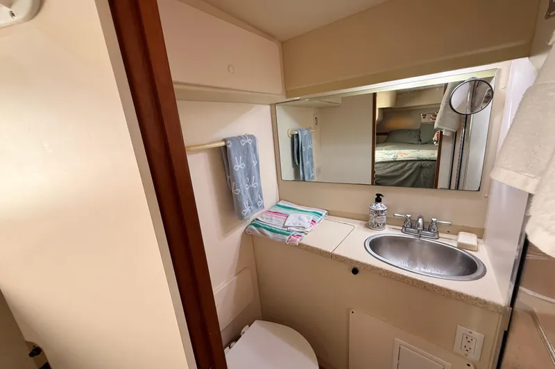 Slide: The Image of Bathroom interior of 1998 Silverton 40 Convertible yacht, featuring sink and mirror. - 69