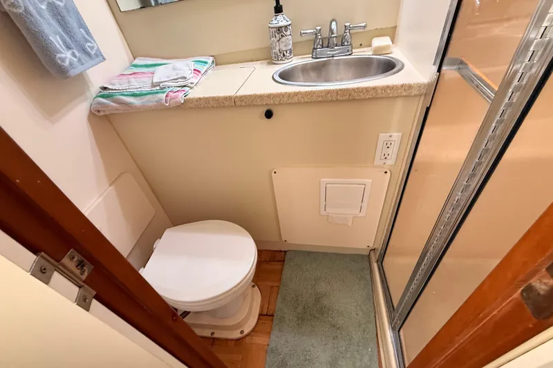 Slide: The Image of Bathroom in 1998 Silverton 40 Convertible yacht with sink, toilet, and shower. - 70