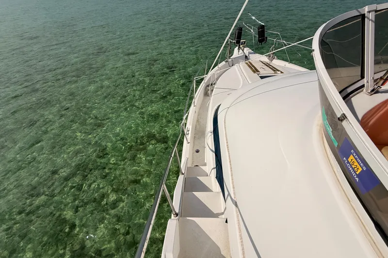 Slide: The Image of 1998 Silverton 40 Convertible yacht on clear turquoise water, Florida registration visible. - 81