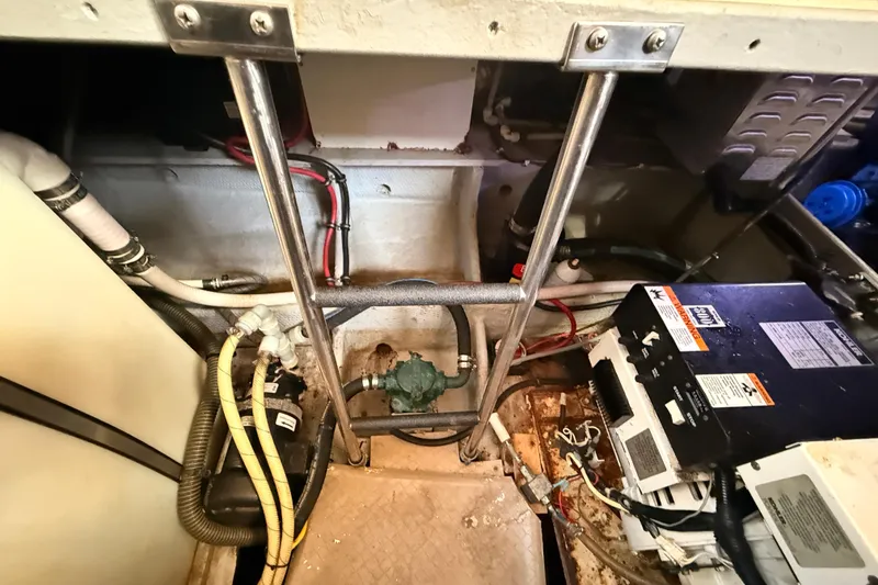 Slide: The Image of Engine room of a 1998 Silverton 40 Convertible boat, showing wiring and mechanical components. - 83