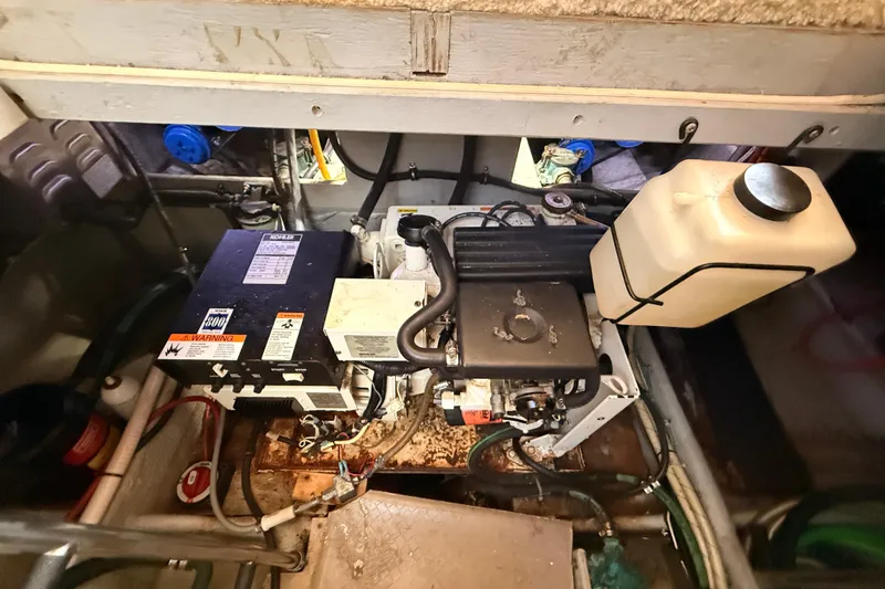 Slide: The Image of Engine compartment of a 1998 Silverton 40 Convertible boat, featuring mechanical components. - 84