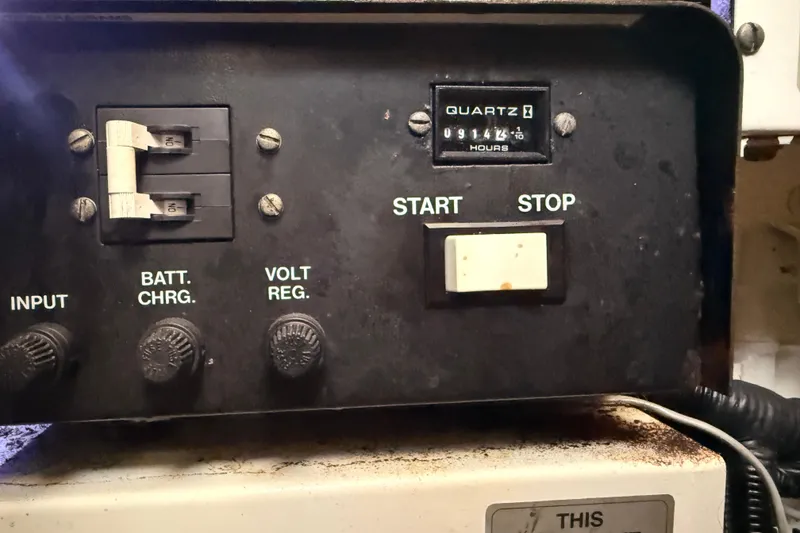 Slide: The Image of Control panel of a 1998 Silverton 40 Convertible boat with hour meter and switches. - 85