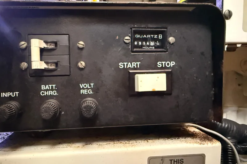 Slide: The Image of Control panel of a 1998 Silverton 40 Convertible boat with switches and hour meter. - 86