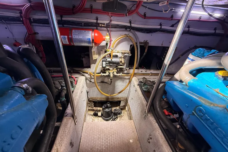 Slide: The Image of Engine room of a 1998 Silverton 40 Convertible boat with visible components and fire extinguisher. - 88