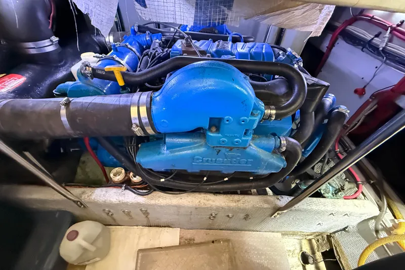 Slide: The Image of Engine compartment of a 1998 Silverton 40 Convertible boat, featuring a blue Crusader engine. - 89
