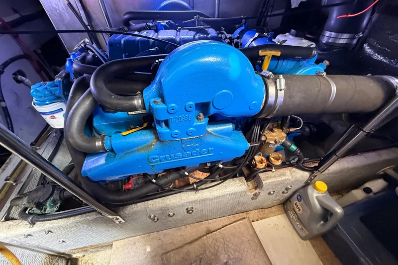 Slide: The Image of 1998 Silverton 40 Convertible engine, featuring a blue Crusader motor in a clean engine room. - 90