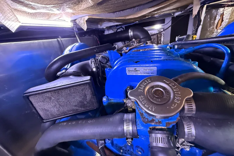 Slide: The Image of Engine compartment of a 1998 Silverton 40 Convertible boat, featuring a Crusader engine. - 91