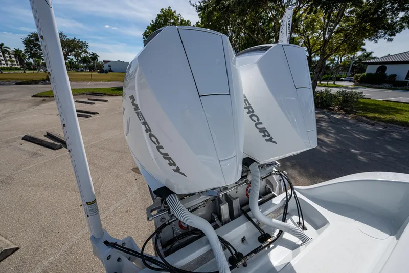 Slide: The Image of 2026 Yellowfin 26 Hybrid with dual Mercury outboard engines in a sunny outdoor setting. - 10