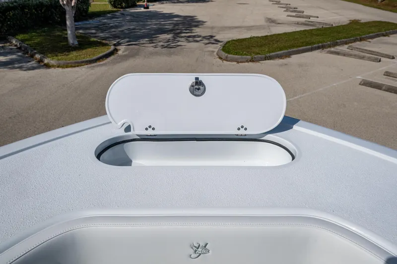 Slide: The Image of 2026 Yellowfin 26 Hybrid boat deck with open storage compartment. - 16