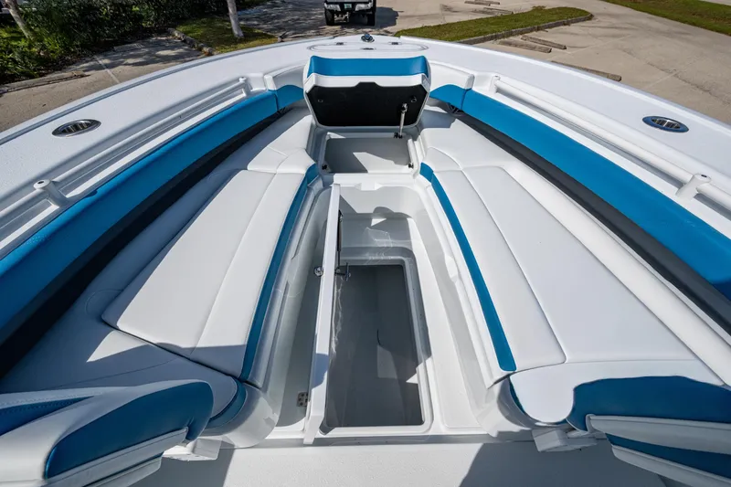 Slide: The Image of 2026 Yellowfin 26 Hybrid boat interior with blue and white seating and storage compartment. - 23