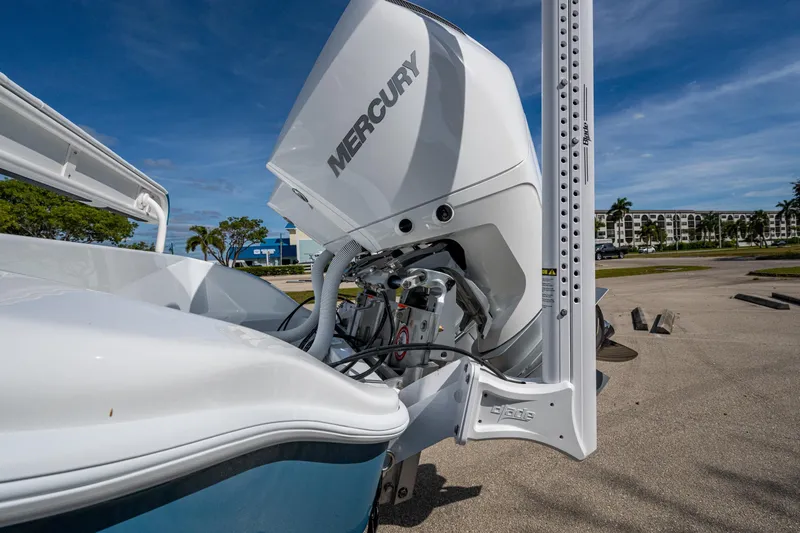 Slide: The Image of 2026 Yellowfin 26 Hybrid boat with Mercury outboard engine, docked under clear blue sky. - 24