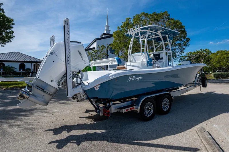 Slide: The Image of 2026 Yellowfin 26 Hybrid boat on trailer, parked outdoors, featuring dual Mercury engines. - 25