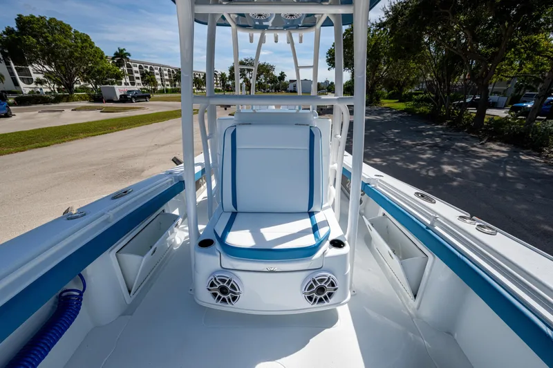 Slide: The Image of 2026 Yellowfin 26 Hybrid boat interior with blue and white seating, outdoor setting. - 26