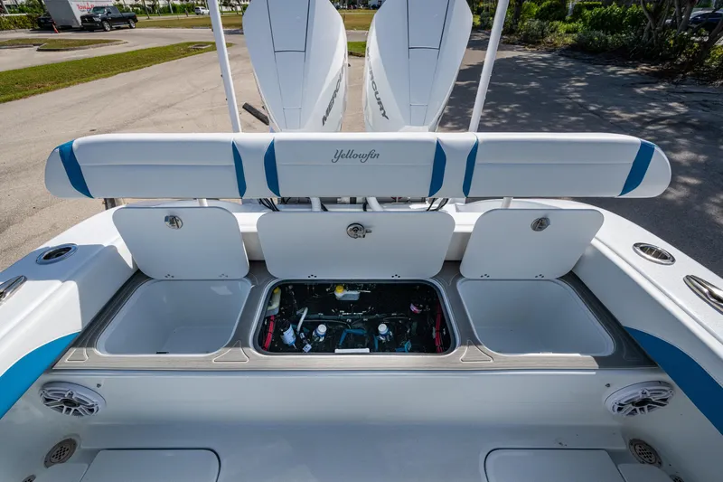 Slide: The Image of 2026 Yellowfin 26 Hybrid boat with open storage compartments and sleek design. - 32