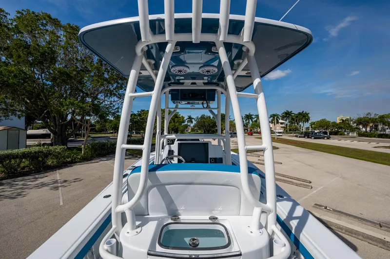 Slide: The Image of 2026 Yellowfin 26 Hybrid boat with T-top, parked in sunny marina setting. - 38